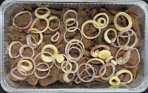 Bistec Encebollado recipe served on a plate, by El Sabor Tropical Restaurant
