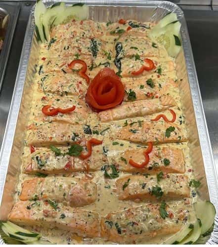 Salmon recipe served on a plate, by El Sabor Tropical Restaurant