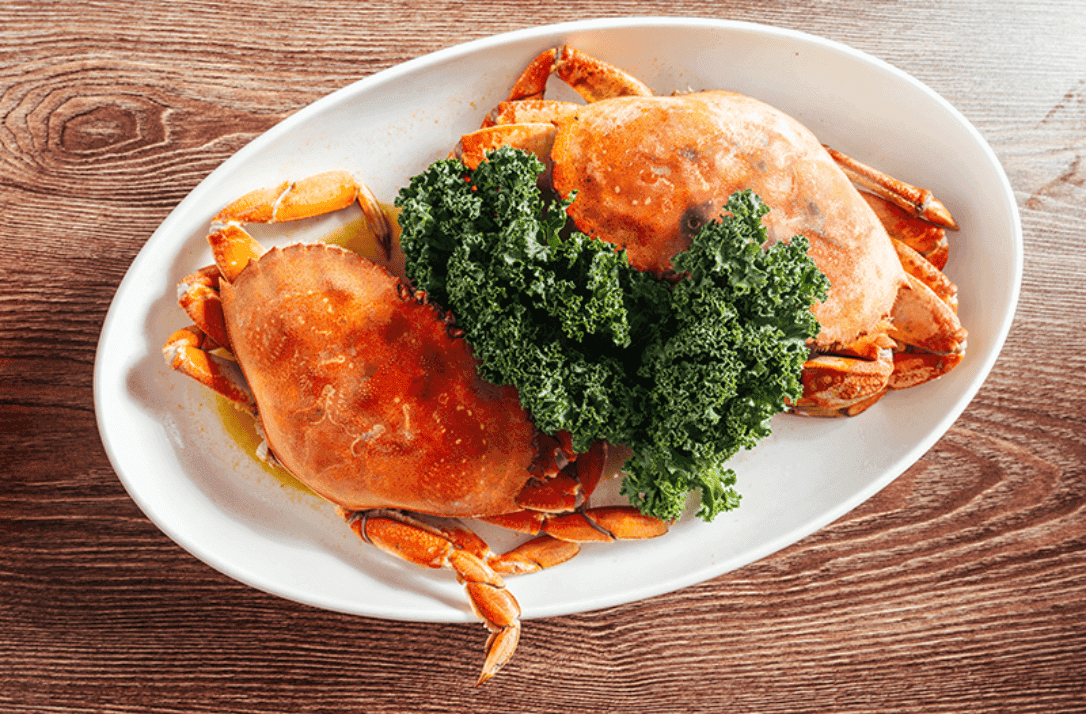 Butter-Baked Whole Crab recipe served on a plate, by Umi Sushi & Seafood Buffet
