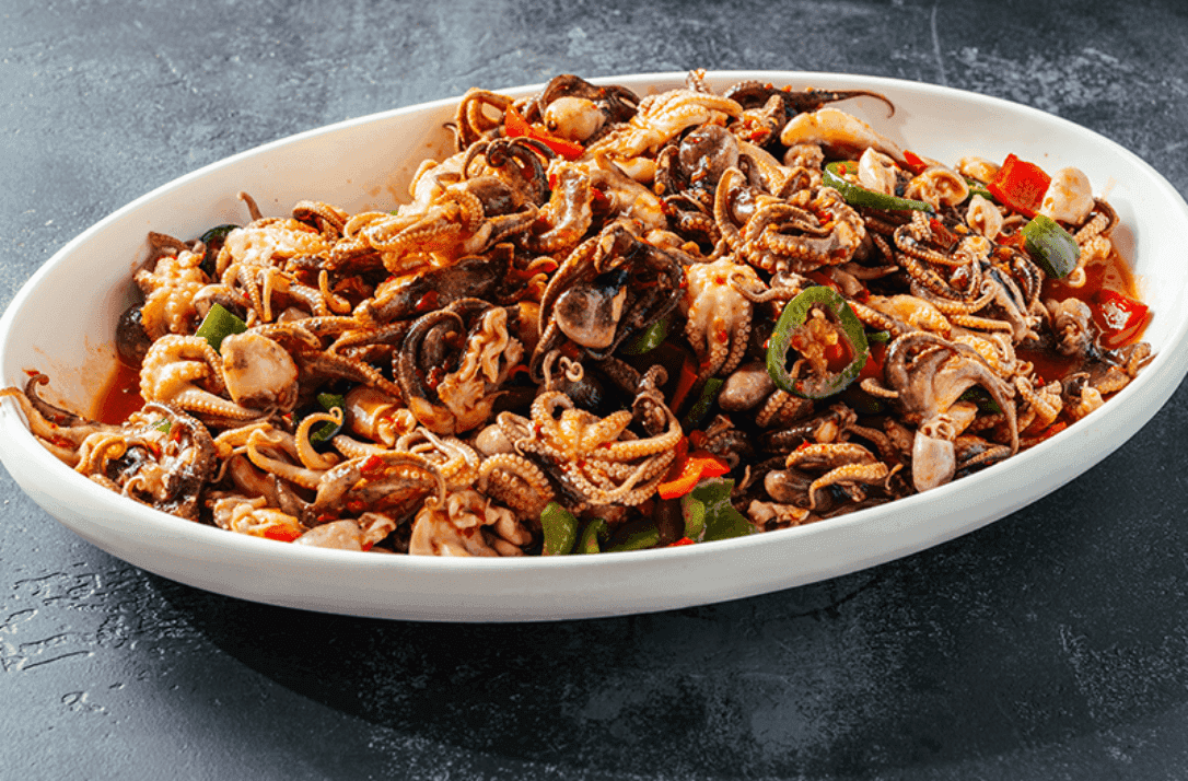 Spicy Stir-Fried Baby Octopus recipe served on a plate, by Umi Sushi & Seafood Buffet