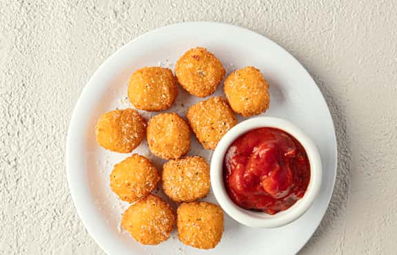 Fried Mozzarella Bites recipe served on a plate, by Fazoli's Fried Mozzarella Bites recipe served on a plate, by Fazoli's