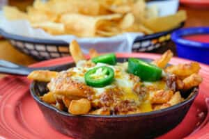 Chili Fries recipe served on a plate, by Joe's Grill & Cantina