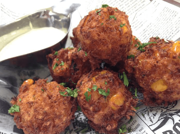 Cajun Crab & Corn Fritters recipe served on a plate, by Joe Fortes