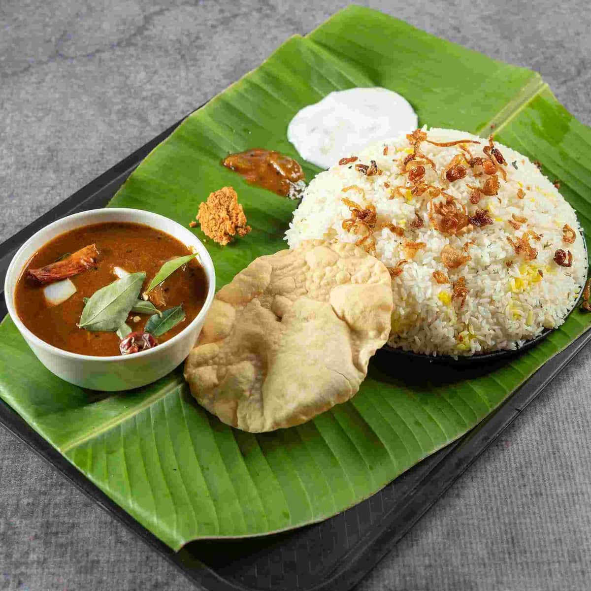 Ghee Rice Beef Curry recipe served on a plate, by The Taste of Kerala restaurant