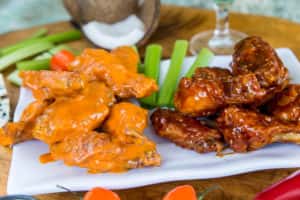 Chicken wings recipe served on a plate, by Island Wing Company Grill & Bar - Tamaya