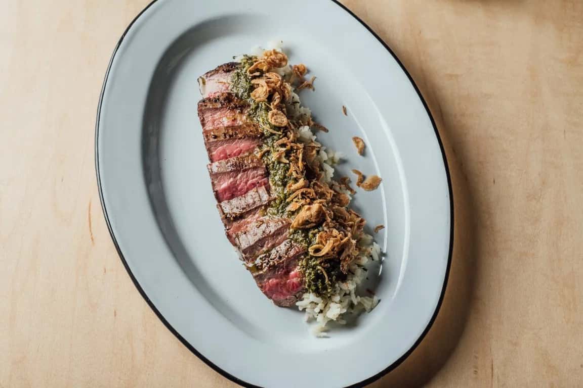 Chimichurri Steak recipe served on a plate, by Spoonbill Watering Hole & Restaurant Chimichurri Steak recipe served on a plate, by Spoonbill Watering Hole & Restaurant