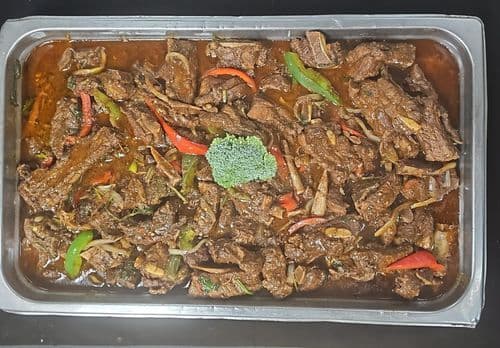 Costilla Guisada recipe served on a plate, by El Sabor Tropical Restaurant