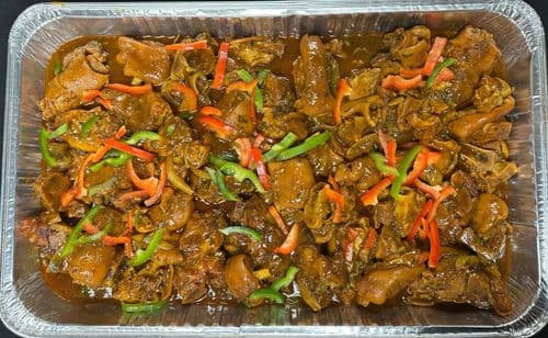 Pollo Guisado recipe served on a plate, by El Sabor Tropical Restaurant