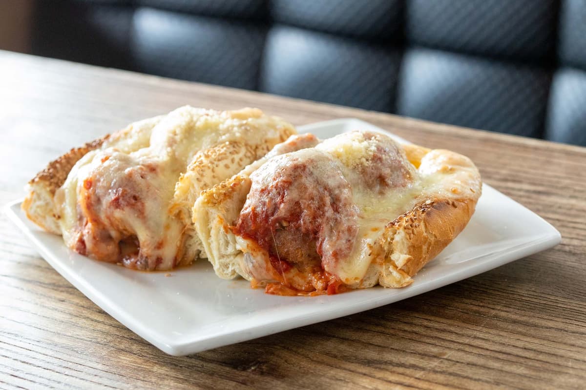 Meatball Sandwich recipe served on a plate, by Cavo's Bar & Kitchen Meatball Sandwich recipe served on a plate, by Cavo's Bar & Kitchen