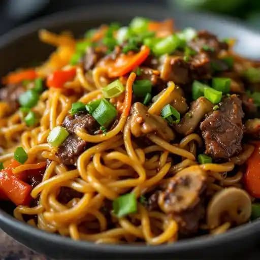 Mongolian Beef Lo Mein recipe served on a plate, by Emil's Hideaway Mongolian Beef Lo Mein recipe served on a plate, by Emil's Hideaway