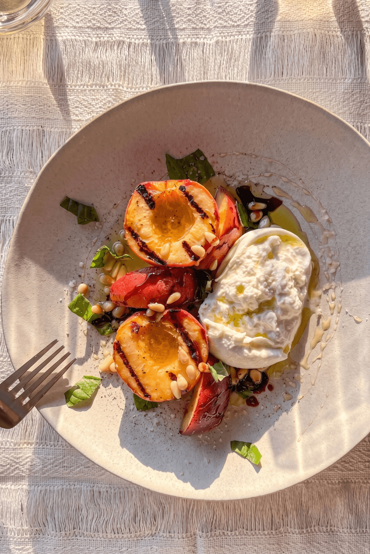Grilled Peach & Burrata recipe served on a plate, by Tommy V's Urban Kitchen & Bar Scottsdale