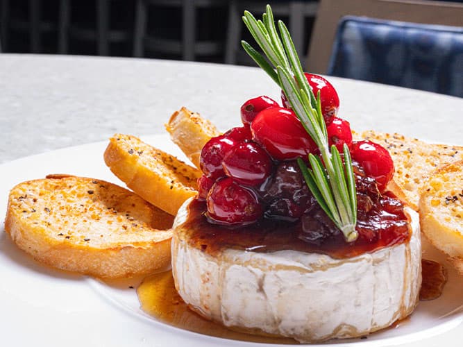 Brie recipe served on a plate, by The Sacred Pepper