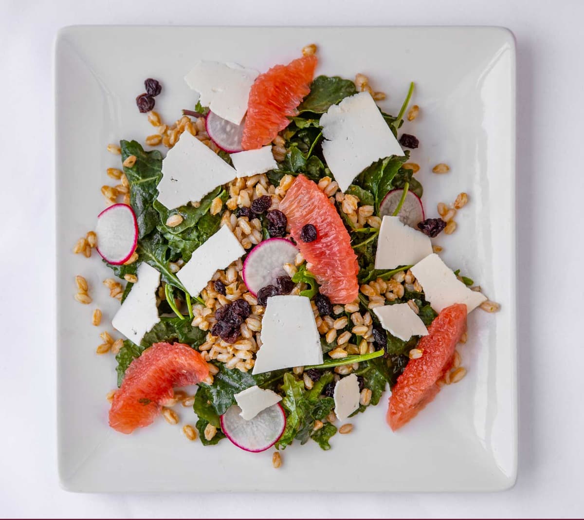 Arugula Grapefruit Salad recipe served on a plate, by Trio's Restaurant Arugula Grapefruit Salad recipe served on a plate, by Trio's Restaurant