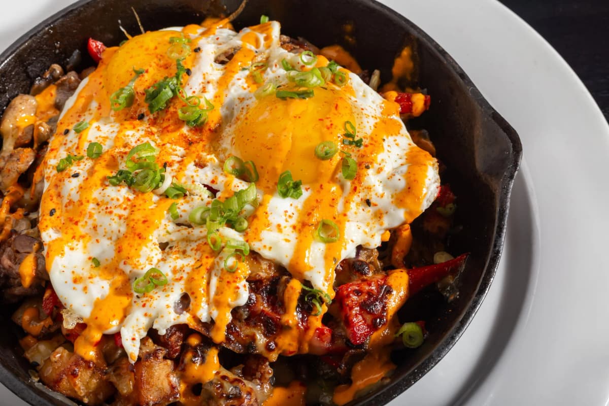 Shaved Prime Skillet recipe served on a plate, by Smokin Fins Shaved Prime Skillet recipe served on a plate, by Smokin Fins