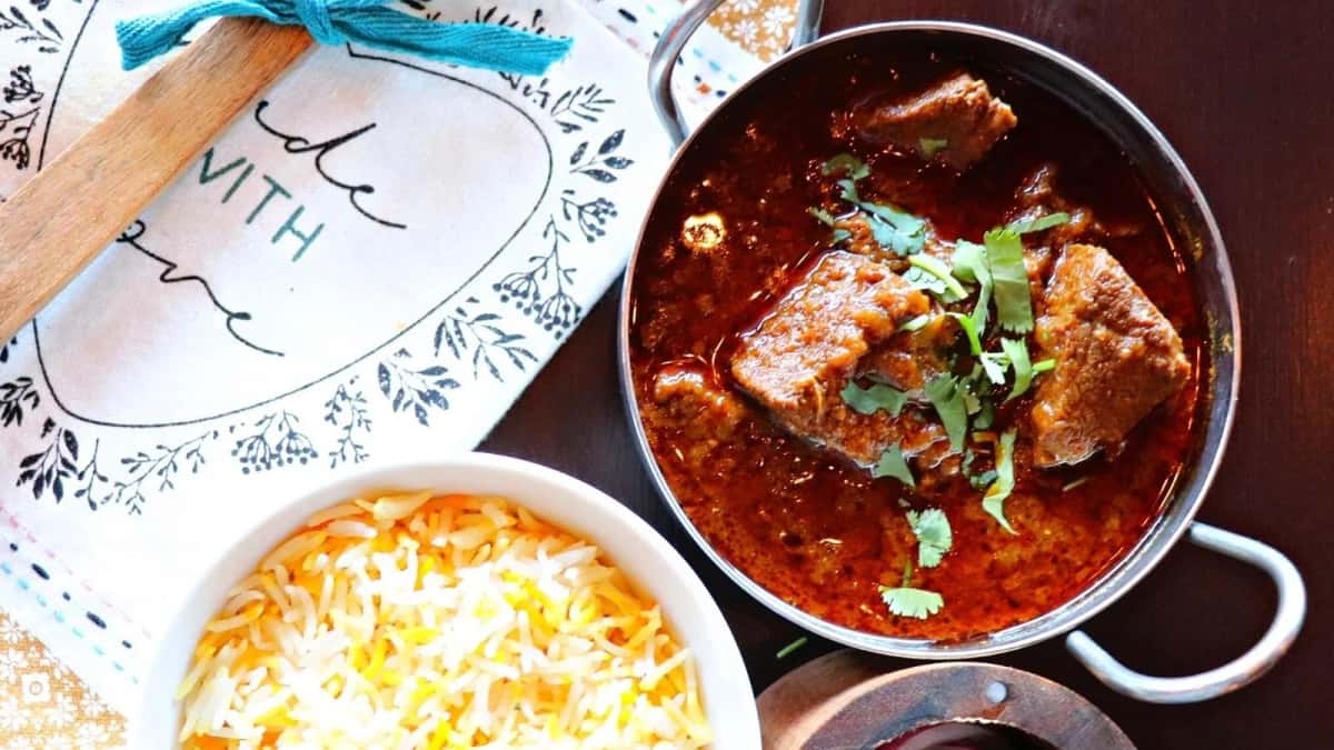 Lamb Rogan Josh recipe served on a plate, by Passage To India Restaurant Lamb Rogan Josh recipe served on a plate, by Passage To India Restaurant