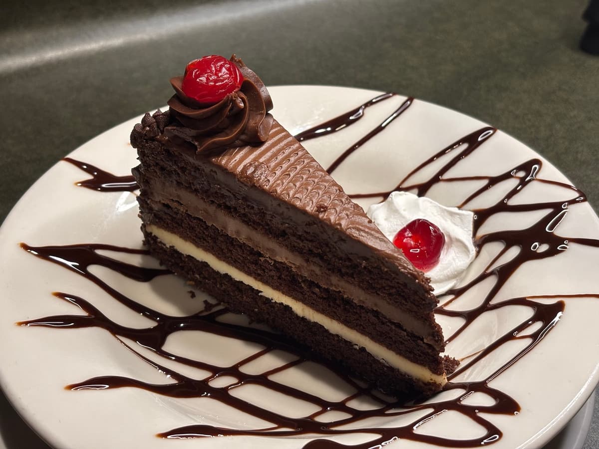 Three Layered Chocolate Divine Cake recipe served on a plate, by Angelo's Italian Restaurant - Wichita Three Layered Chocolate Divine Cake recipe served on a plate, by Angelo's Italian Restaurant - Wichita