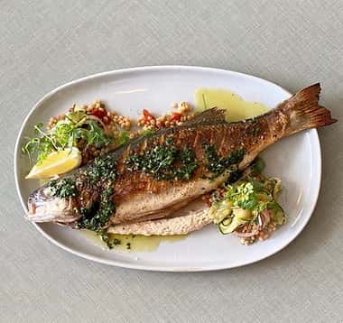 Branzino recipe served on a plate, by The Strand Branzino recipe served on a plate, by The Strand