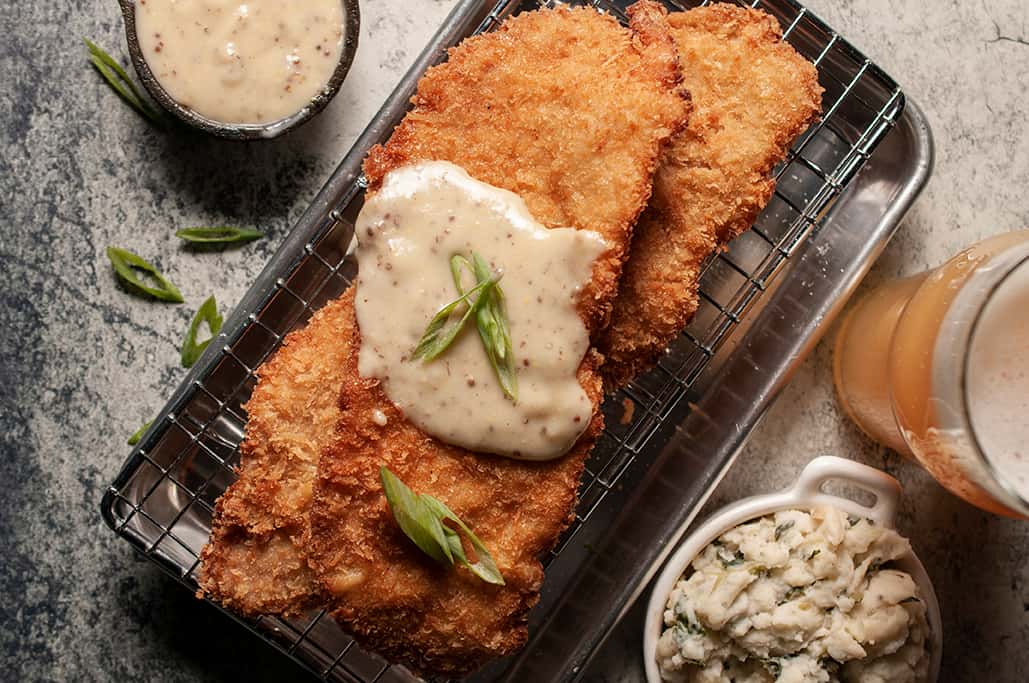 Pork Schnitzel recipe served on a plate, by The Moot House Pork Schnitzel recipe served on a plate, by The Moot House