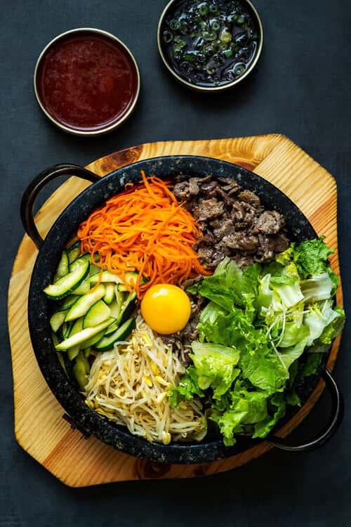 Stone Pot Bibimbap recipe served on a plate, by Baekjeong Temple City Stone Pot Bibimbap recipe served on a plate, by Baekjeong Temple City